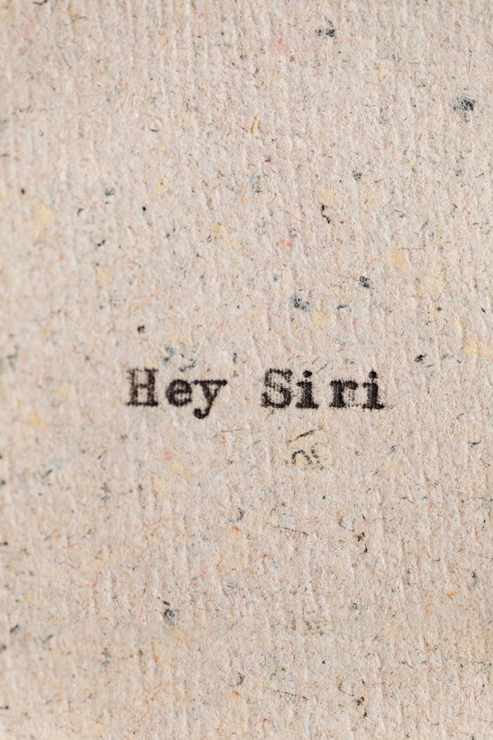 The Art of Drawing Readers In: Your attractive post title goes here Close-up of the phrase 'Hey Siri' typed on vintage textured paper, resembling classic typewriter style.